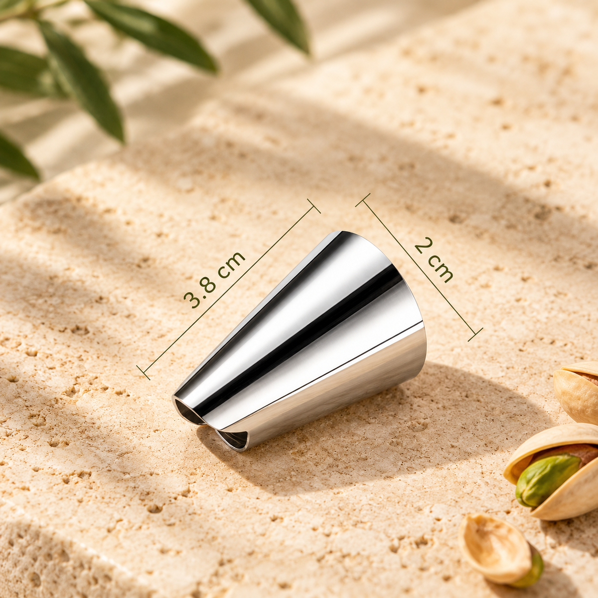 Stainless steel nut opener finger guard with dimensions marked as 3.8 cm long and 2 cm wide